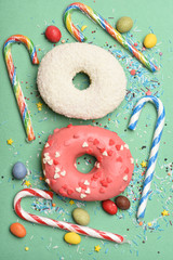 Glazed donuts on green background