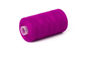 Still life of a magenta spool of thread on a white background - Closeup Detail