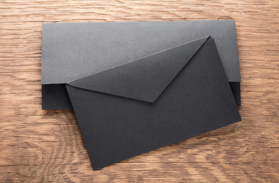 black envelope on  wooden table