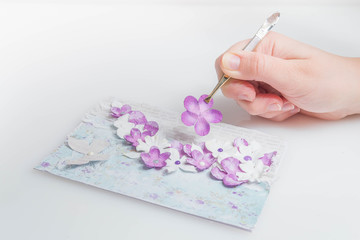 Scrapbooking card of violet flowers on a white background