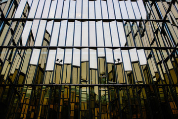 Reflection of modern office building glass wall and window, useful for business.