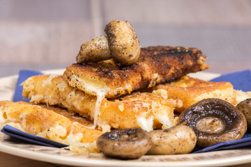Fried mushroom with fried yellow cheese on eggs