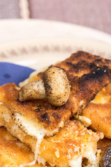 Fried mushroom with fried yellow cheese on eggs