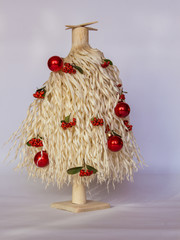 White wood shavings Christmas tree with red berries and red ornament