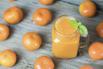 Freshly squeezed healthy citrus tangerine juice in jar and ripe