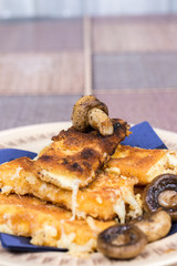 Fried mushroom with fried yellow cheese on eggs