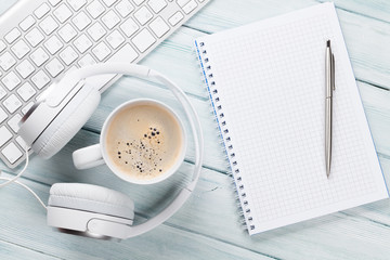 Headphones, coffee, notepad and pc