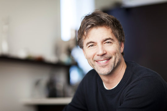 Portrait Of A Mature Man Smiling At The Camera. Home