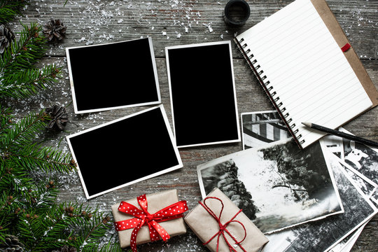 blank photo frames on christmas wooden background