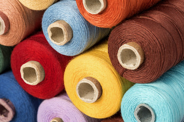 Still life of colorful spools of thread on a white background - Closeup Detail