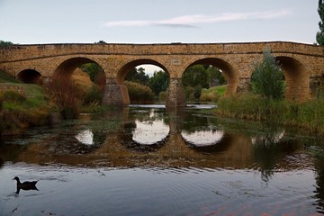 Fototapeta na wymiar Old bridge over a river