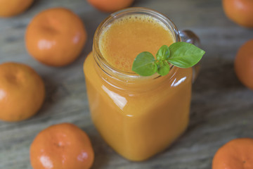 Freshly squeezed healthy citrus tangerine juice in jar and ripe