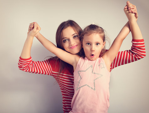 Playful Mother And Crazy Joking Grimacing Kid Holding Each Other