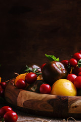 Various tomatoes on old wooden table, selective focus