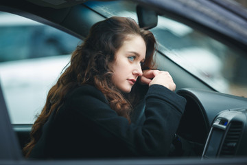 Fototapeta na wymiar Young woman in a car