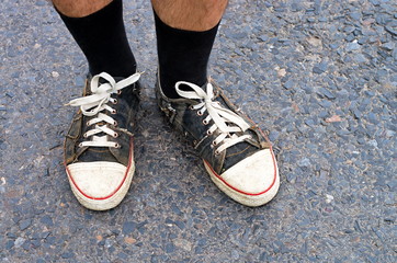 Runner legs in sneakers on the road