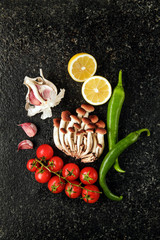 Obraz na płótnie Canvas Fresh Vegetables on a marble table : garlic, cherry tomatoes, ho