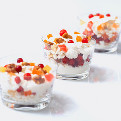 Glass jars with cream cheese and sour cream, cranberries and can