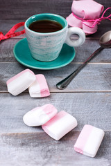 Сup of coffee, a jar of jam and marshmallows