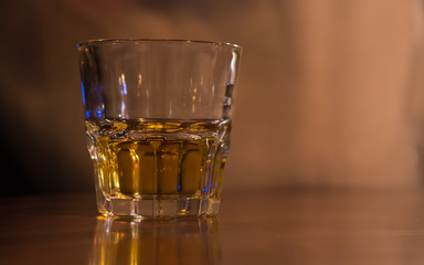 Glass of drink. Double whiskey glass on table in bar