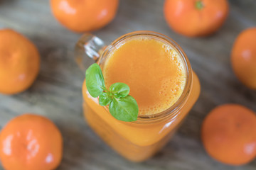 Freshly squeezed healthy citrus tangerine juice in jar and ripe