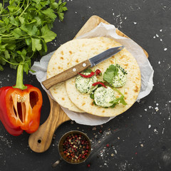 Green homemade butter from organic farming products based on seasonal herbs, parsley, cilantro, rosemary, thyme and pepper  sea salt. Served with tortillas  fresh bread for a snack. Selective focus