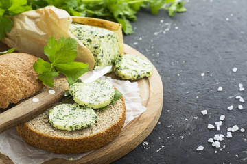 Green homemade butter from organic farming products based on seasonal herbs, parsley, cilantro, rosemary, thyme and pepper  sea salt. Served with tortillas  fresh bread for a snack. Selective focus
