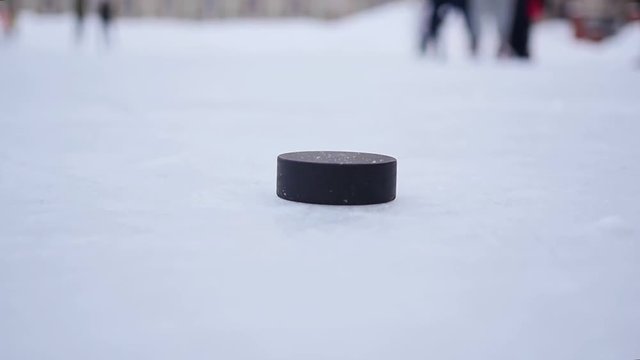 Slow Motion Hockey - player shot a stick on the puck closeup
