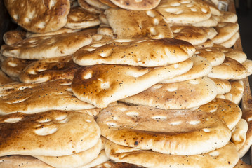 Flat bread pita. Fresh Pita breads in a bakery.  Traditional bread for holy month Ramadan. Food background. (selective focus)