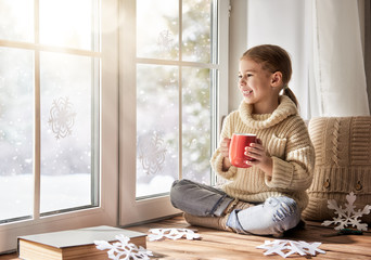 Child makes paper snowflakes