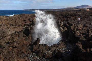 Boiling sea water. Volcanic coastline.