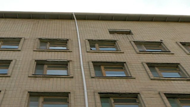 Office or factory block building exterior pan and tilt shot.