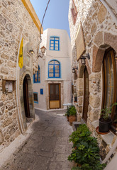 October 6, 2015, Editorial. Greece, Nisyros, Mandraki, medieval streets, blue windows, pavement of natural stone.