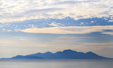 Islands in the sea and clouds in the sky at dawn, background
