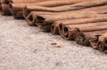 cinnamon sticks on a gray brown linen background