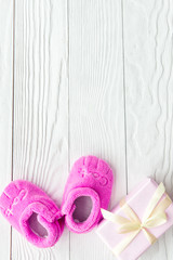 pink baby's bootees on wooden background