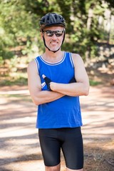 Mature bike rider man posing with arms crossed