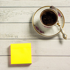 Coffee cup on wooden table with copy space. Square