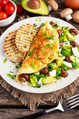Mushroom, Feta Cheese egg Omelette witch Avocado, vegetables, lettuce, herbs and grilled bread.