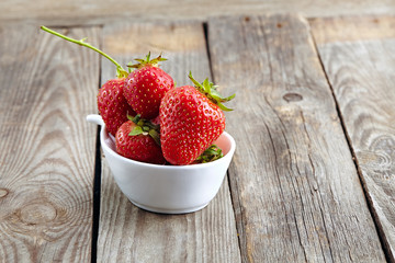 fresh juicy organic strawberries on an old wooden textured table