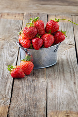 fresh juicy organic strawberries on an old wooden textured table