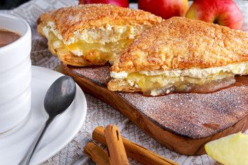 Puff pastry Turnovers apple cake dessert with whipped cream and hot coffee.