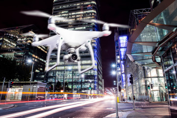 Fototapeta na wymiar Hovering drone taking pictures of city of London at night