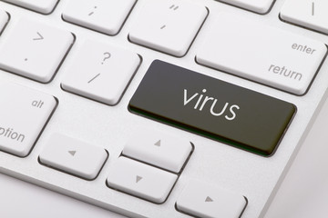 Virus word written on computer keyboard.