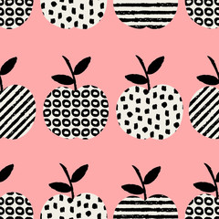 Seamless pattern with apples in black and white on pink background.
