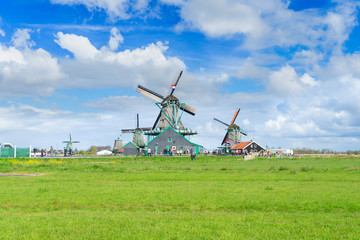 Fototapeta premium traditional Dutch scenery with windmill of Zaanse Schans with dramatic sky, Netherlands
