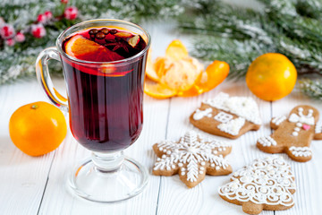 Christmas mulled wine with spices in cup on wooden background