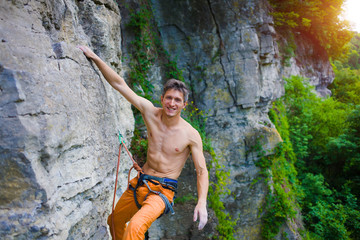 Climber climbs the rock.