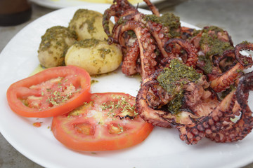 Fried octopus with tomato and mojo potatoes, typical dish of the