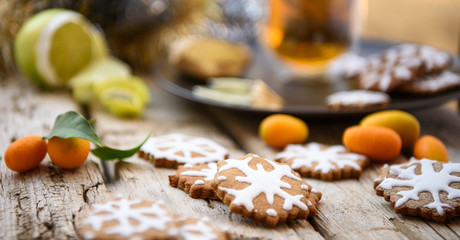 Christmas homemade gingerbread cookies, lemon and oranges on wooden table. Winter holiday still life